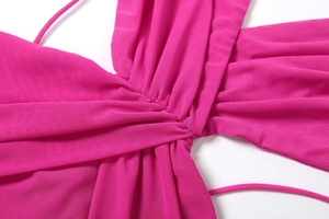 Detail of magenta mesh dress featuring a central twist design and delicate sheer fabric