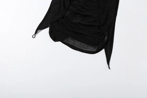 Detail view of black ruched mesh dress featuring asymmetric pointed hem and string loops