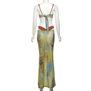 Rear view of women's three-piece set featuring lace-up top and abstract print maxi skirt