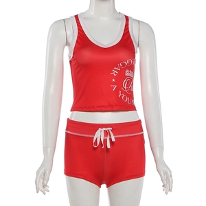 Detail of red sports set featuring white letter print and drawstring waist shorts