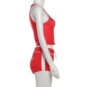 Close-up of red and white contrast shorts featuring a drawstring waist and Team lettering