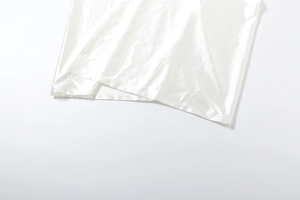 Macro shot of pearl white satin dress hem with fine stitching and silky texture