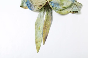 Macro shot of abstract oil painting print bikini top with front tie-knot detail