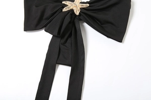 Detail of black strapless top featuring golden starfish metal buckle and tie straps