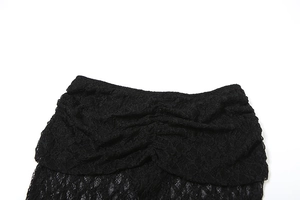 Detail of black lace skirt showing intricate floral patterns and elastic pleated waist texture