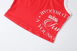 Detail of red knit crop top with white crown print and A YOUNG BEGGAR text