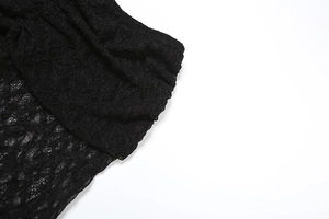 Detail of black lace fabric with intricate floral patterns and ruched texture design