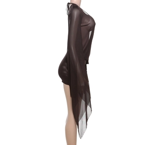 Macro detail of sheer brown mesh fabric and flared long sleeves on this mini dress