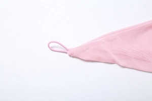 Macro shot of pink mesh fabric detail with fine elastic loop and neat stitching