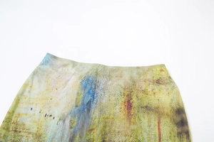 Detail of colorful abstract oil painting print on high-waisted skirt with flat seam stitching