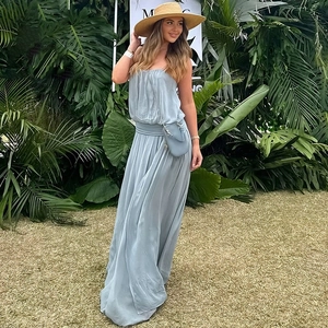 Light blue strapless maxi dress with cinched waist and straw hat for summer vacations