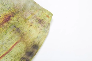 Detailed close-up of fine stitching and forest style print on high-waist skirt hemline