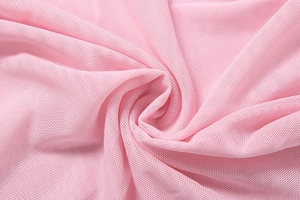 Detail shot of soft pink mesh fabric showing fine honeycomb texture and light pleats