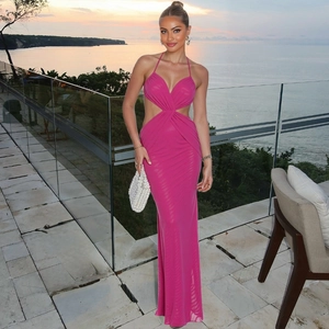 Hot pink halter neck maxi dress with side cut-outs and open back for summer beach parties