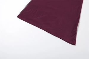 Gros plan de l'ourlet de robe prune montrant le tissu voilé et les coutures à double aiguille