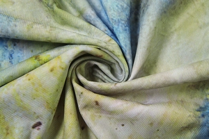 Detail view of colorful knit fabric with yellow blue green dye and fine horizontal texture