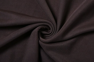 Close-up of deep brown sheer mesh fabric texture with delicate woven spiral detail