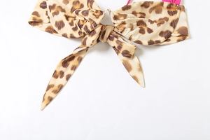 Detail of leopard print bikini top with pink straps and decorative center bow tie