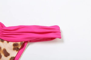 Detail of hot pink ruffled waistband and leopard print fabric with neat stitching