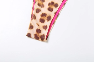 Detail shot of leopard print swimwear with vibrant pink lining and stitched edges