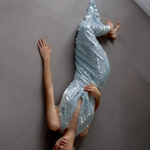 Detailed view of light blue sequins on a slim fit fisquail dress with shimmering texture