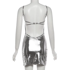 Detailed back view of a metallic silver mini dress with sexy open back and cross straps
