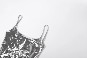 Detail of silver metallic textured fabric and thin straps on backless bodycon dress