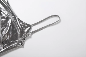 Detail of silver metallic dress featuring adjustable spaghetti straps and glossy texture