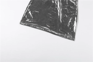 Detailed close-up of metallic silver dress hem showing double-stitched reinforced sewing