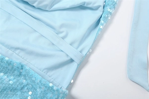 Macro shot of light blue sequin fabric with smooth inner lining and side stitching details