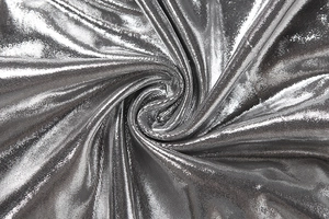Close-up of silver metallic fabric showing fine sequin texture and honeycomb pattern