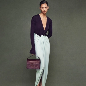 Detail of elegant two-tone V-neck maxi dress with front twist and thigh-high slit detail
