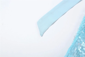 Detail of light blue sequined fabric and halter neck strap on backless dress