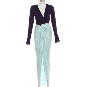 Detail of elegant two-tone dress with deep V-neck, waist knot and high front slit