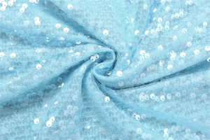 Close-up of light blue sequin fabric with shimmering round details on transparent mesh