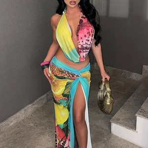 Detail of tropical print summer set featuring halter neck top and high slit skirt