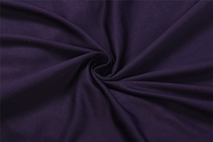 Close-up of dark purple knit fabric showing diagonal twill weave and soft texture