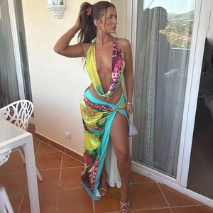 Detail of summer halter neck backless top and high slit skirt with vibrant leopard print
