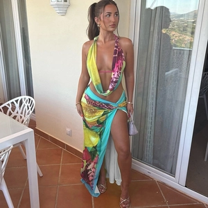 Detail of summer two-piece set featuring abstract print halter top and high slit maxi skirt