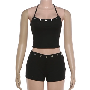 Detail of black ribbed knit two-piece set with shell button accents on waist and neckline