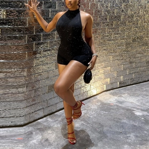 Detail of a black backless halter romper with sparkly rhinestones for evening wear