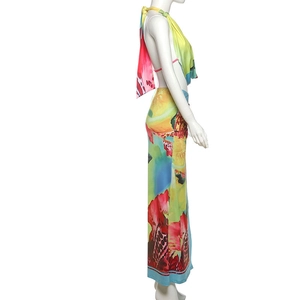 Detailed side view of halter neck backless crop top and vibrant printed split maxi skirt