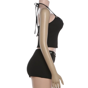 Close-up of black ribbed knit crop top and shorts set with decorative buttons