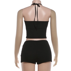 Back view of a black halter crop top and high-waist shorts set in ribbed knit fabric