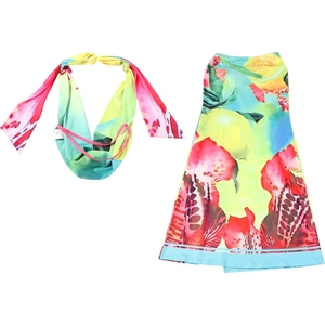Detail of colorful halter top and skirt set with tropical floral patterns in pink and yellow