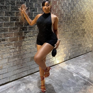 Detail of a sparkly black halter neck romper with shimmering sequins and open back