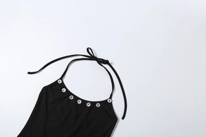 Detail of black ribbed halter top featuring shell buttons and bow tie shoulder straps