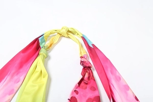 Detail of halter neck tie and vibrant abstract watercolor print on summer set fabric