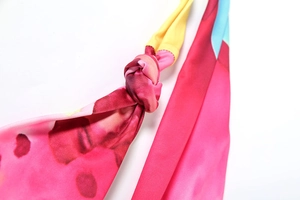 Detailed close-up of the colorful halter neck top featuring vibrant abstract print fabric