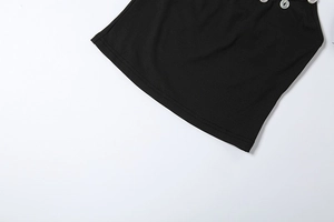 Detail of black ribbed knit fabric with decorative white pearl buttons on the neckline